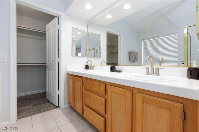 1246 E Gary Ave, Las Vegas, NV 89123 - full bath with a walk in closet, tile patterned floors, double vanity, and recessed lighting