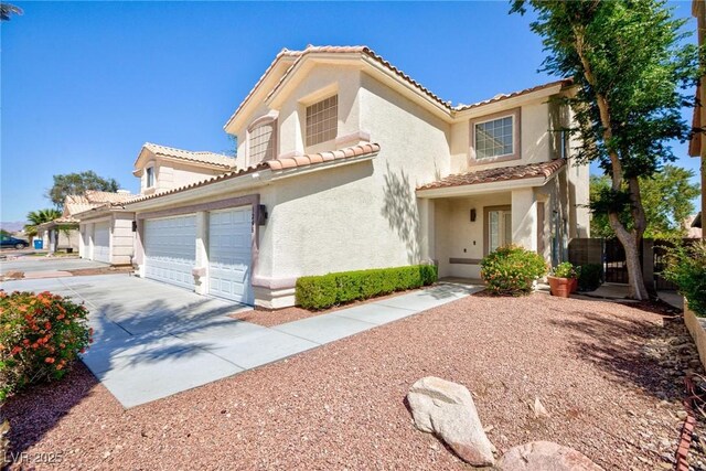 1246 E Gary Ave, Las Vegas, NV 89123 - mediterranean / spanish-style house featuring concrete driveway, stucco siding, a tiled roof, and a garage