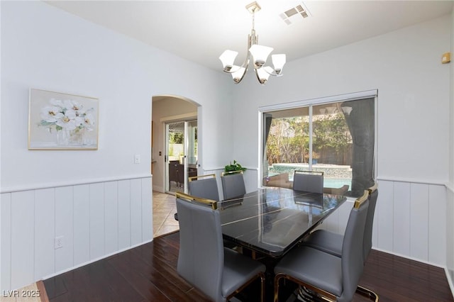 1246 E Gary Ave, Las Vegas, NV 89123 - dining area with arched walkways, a chandelier, hardwood / wood-style flooring, and a wainscoted wall