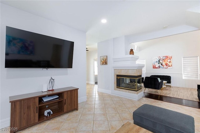 1246 E Gary Ave, Las Vegas, NV 89123 - living area with light tile patterned floors, a tiled fireplace, and baseboards