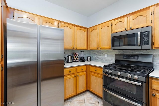 1246 E Gary Ave, Las Vegas, NV 89123 - kitchen with stainless steel appliances, light countertops, backsplash, and light tile patterned flooring
