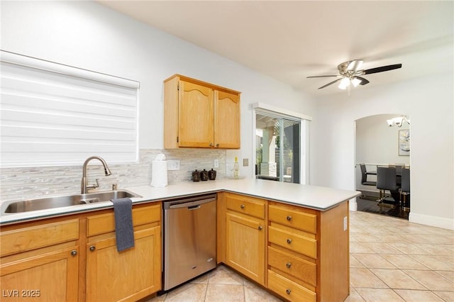 1246 E Gary Ave, Las Vegas, NV 89123 - kitchen with dishwasher, a sink, a peninsula, light tile patterned floors, and tasteful backsplash