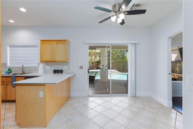 1246 E Gary Ave, Las Vegas, NV 89123 - kitchen featuring a sink, decorative backsplash, light countertops, a peninsula, and ceiling fan