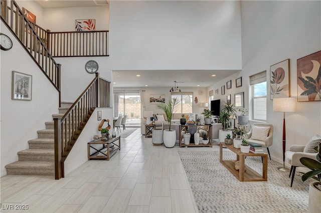 8801 Trotternish Ridge Dr, Las Vegas, NV 89166 - living room featuring stairs, a high ceiling, and recessed lighting