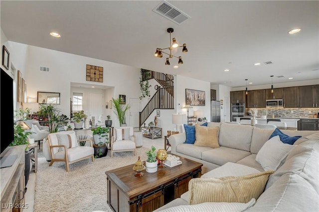 8801 Trotternish Ridge Dr, Las Vegas, NV 89166 - living room with stairs, recessed lighting, and light carpet