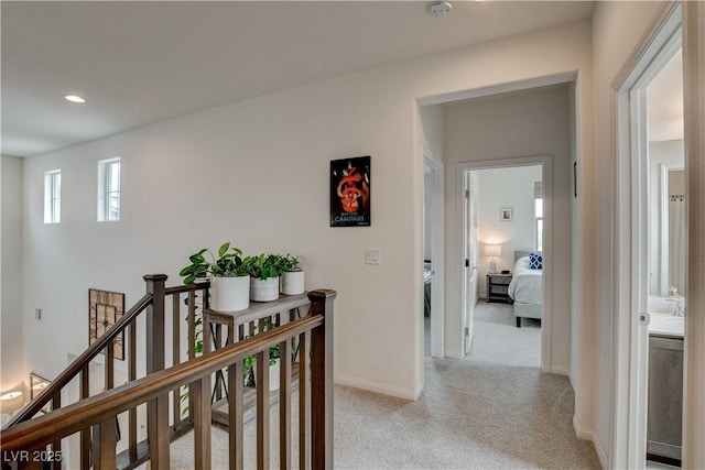 8801 Trotternish Ridge Dr, Las Vegas, NV 89166 - hall with light carpet, baseboards, an upstairs landing, and recessed lighting
