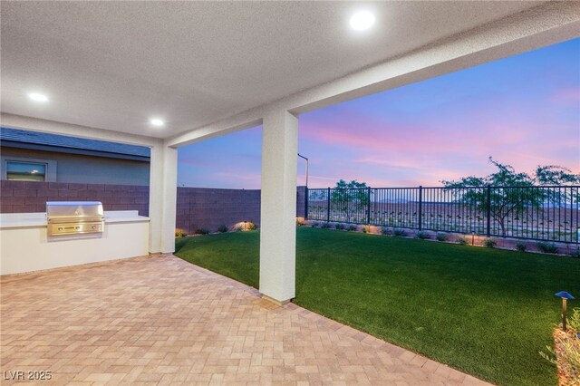 patio terrace at dusk with area for grilling