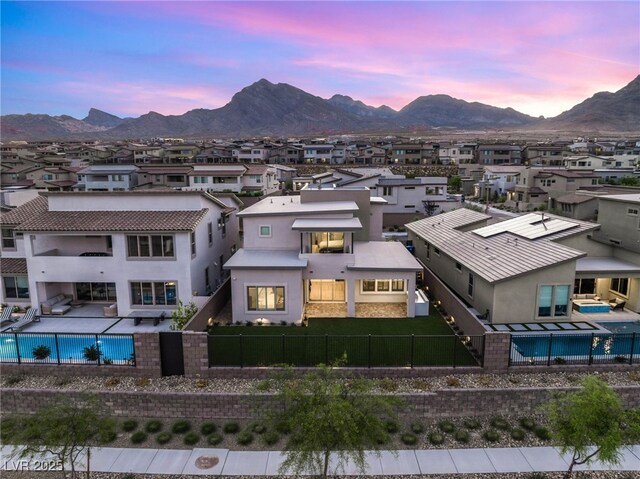 aerial perspective of suburban area with a pool area and mountains