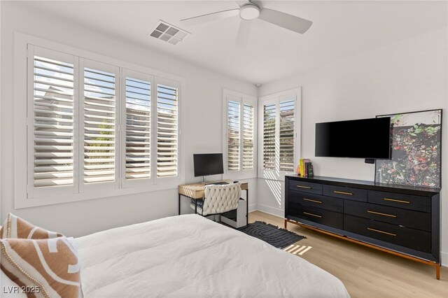 bedroom featuring light wood-type flooring, baseboards, and ceiling fan