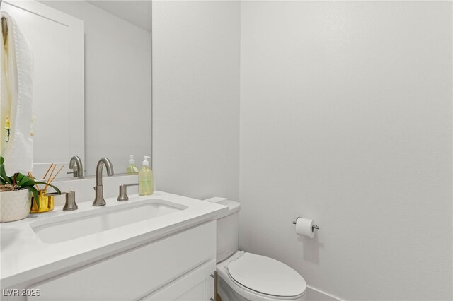 bathroom featuring toilet and vanity