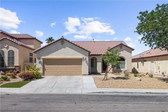 1006 Cove Palisades Dr, North Las Vegas, NV 89031 - mediterranean / spanish-style house with a garage, stucco siding, concrete driveway, and a tile roof