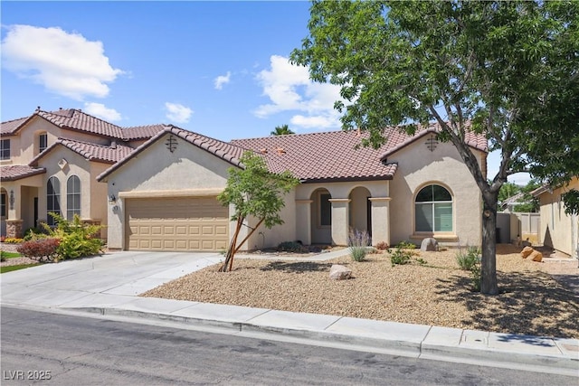 1006 Cove Palisades Dr, North Las Vegas, NV 89031 - mediterranean / spanish-style house featuring an attached garage, stucco siding, and a tiled roof
