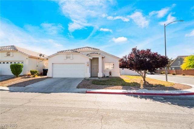 3839 Dusty Glen Ct, North Las Vegas, NV 89032 - view of front facade with an attached garage, driveway, stucco siding, a tile roof, and fence
