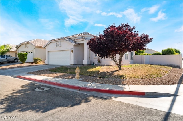 3839 Dusty Glen Ct, North Las Vegas, NV 89032 - view of front of property featuring fence, an attached garage, stucco siding, driveway, and a tiled roof
