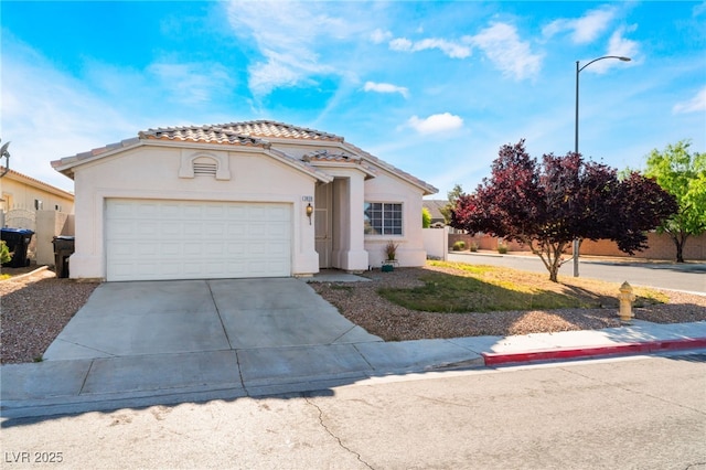 3839 Dusty Glen Ct, North Las Vegas, NV 89032 - mediterranean / spanish house featuring a tile roof, driveway, a garage, and stucco siding