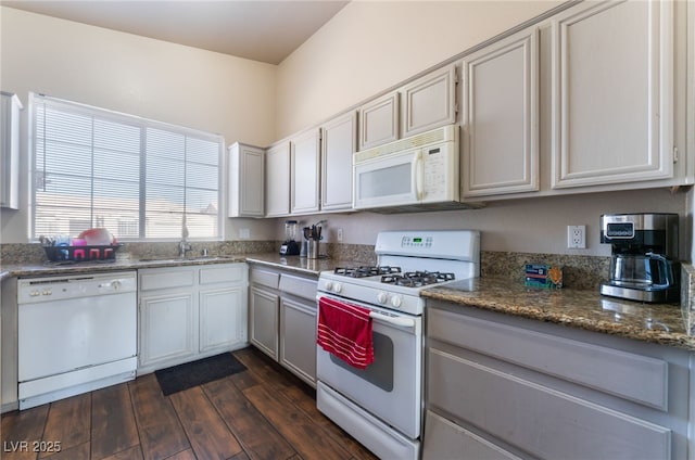 3839 Dusty Glen Ct, North Las Vegas, NV 89032 - kitchen with white appliances, a sink, dark wood finished floors, and dark stone countertops