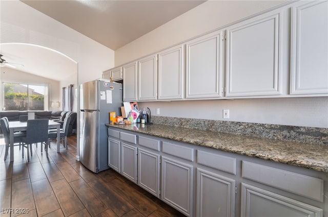 3839 Dusty Glen Ct, North Las Vegas, NV 89032 - kitchen with freestanding refrigerator, lofted ceiling, gray cabinetry, dark wood-style flooring, and ceiling fan