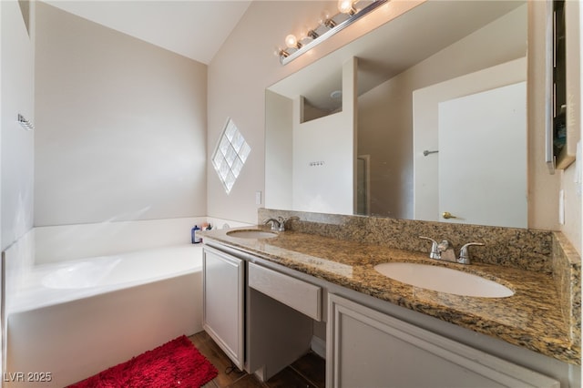 3839 Dusty Glen Ct, North Las Vegas, NV 89032 - bathroom featuring a garden tub, double vanity, and lofted ceiling