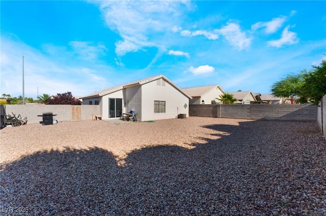 3839 Dusty Glen Ct, North Las Vegas, NV 89032 - back of property featuring stucco siding, a tile roof, and a fenced backyard