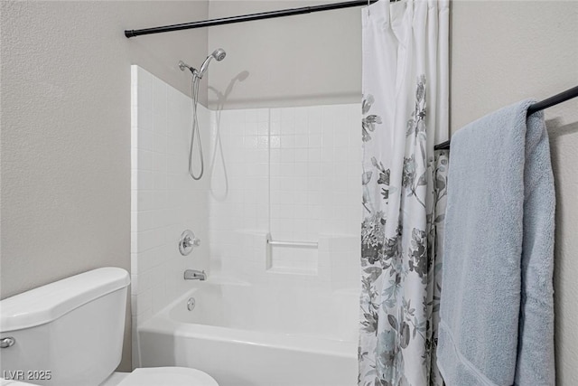 full bathroom featuring toilet, shower / bath combo, and a textured wall