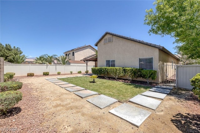 view of side of property featuring stucco siding and a gazebo