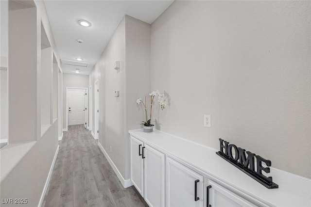 hallway with light wood-style flooring, recessed lighting, and baseboards
