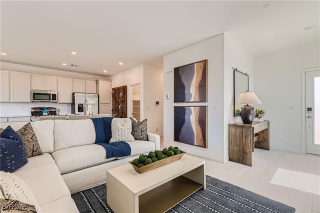 living area with recessed lighting and baseboards