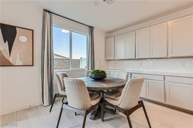 dining area featuring baseboards