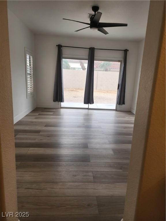 8355 Cabin Peak St, Las Vegas, NV 89123 - spare room with plenty of natural light, wood finished floors, ceiling fan, and baseboards