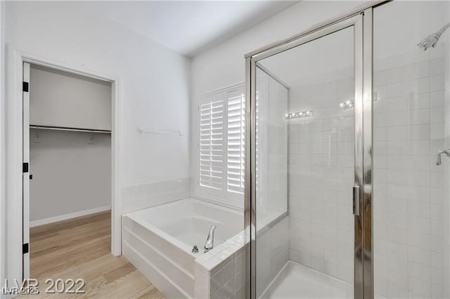 8355 Cabin Peak St, Las Vegas, NV 89123 - full bath featuring a stall shower, a bath, wood finished floors, and a walk in closet