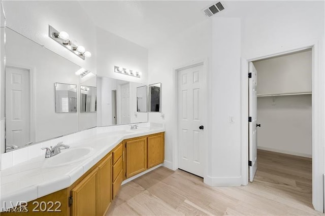 8355 Cabin Peak St, Las Vegas, NV 89123 - full bathroom with wood finished floors, double vanity, and baseboards