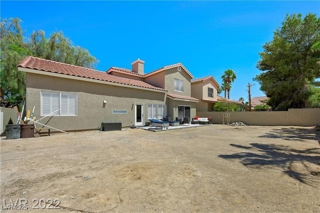 8355 Cabin Peak St, Las Vegas, NV 89123 - back of house with a chimney, fence, a tile roof, stucco siding, and a patio area