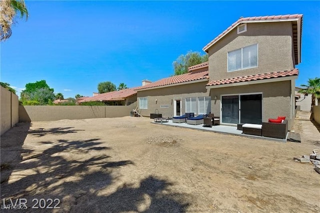 8355 Cabin Peak St, Las Vegas, NV 89123 - back of house featuring an outdoor hangout area, stucco siding, a fenced backyard, and a tile roof