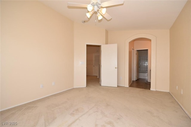 8842 Duncan Barrel Ave Unit 101, Las Vegas, NV 89178 - unfurnished room featuring arched walkways, carpet, a ceiling fan, and baseboards
