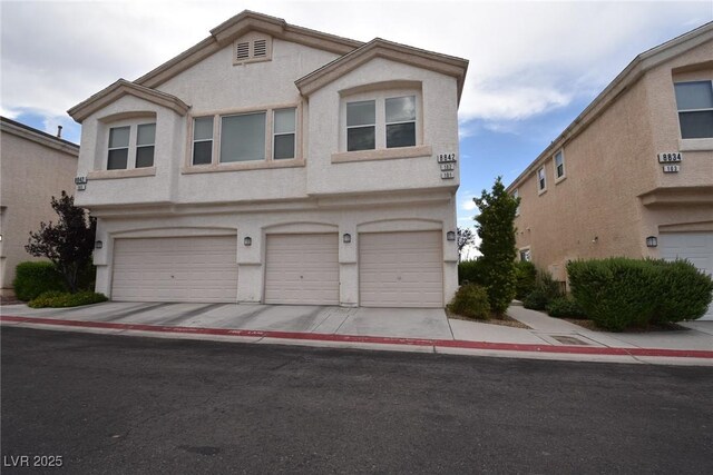 8842 Duncan Barrel Ave Unit 101, Las Vegas, NV 89178 - view of front of house with stucco siding and an attached garage