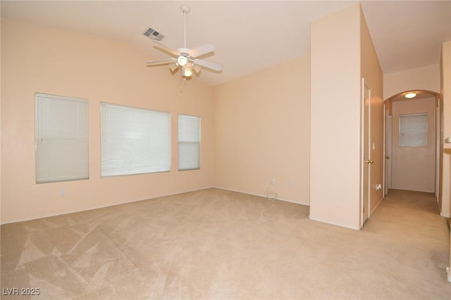 8842 Duncan Barrel Ave Unit 101, Las Vegas, NV 89178 - spare room featuring arched walkways, vaulted ceiling, ceiling fan, and light carpet