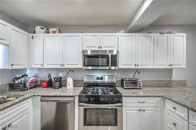 4078 Gold Coast Dr, Las Vegas, NV 89121 - kitchen with stainless steel appliances and white cabinetry