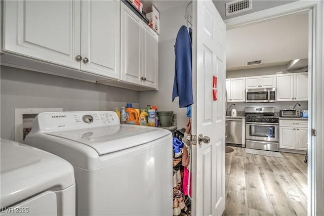 4078 Gold Coast Dr, Las Vegas, NV 89121 - clothes washing area featuring washer and dryer and light wood-style flooring
