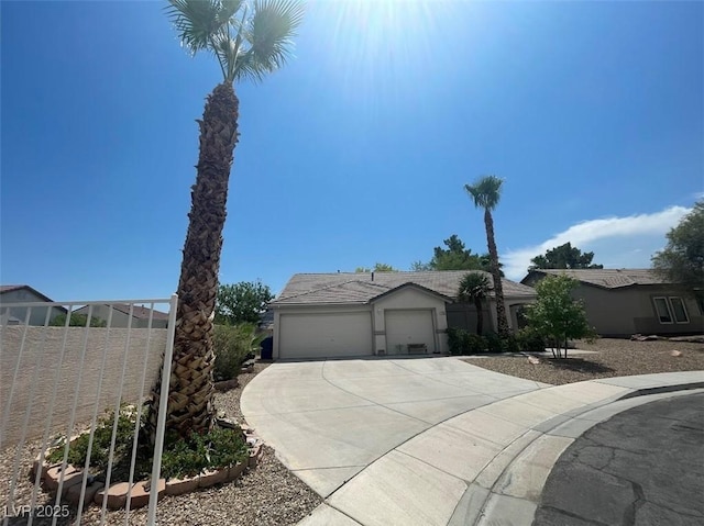 ranch-style house featuring concrete driveway, fence, and stucco siding