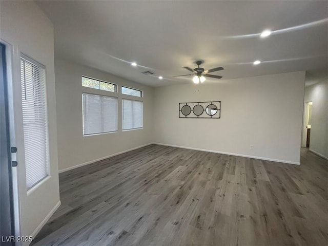 spare room with wood finished floors, baseboards, ceiling fan, and recessed lighting