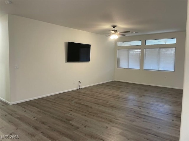 empty room featuring wood finished floors, ceiling fan, and baseboards