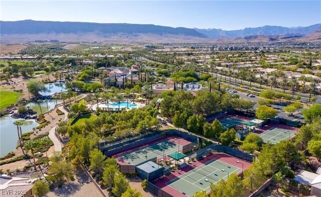 aerial perspective of suburban area with a mountainous background and a pool