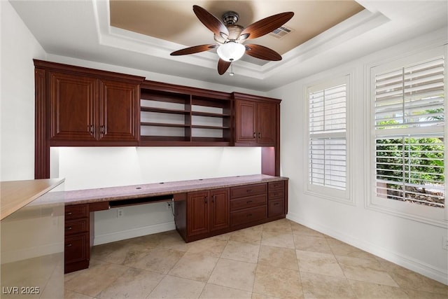 5067 Pensier St, Las Vegas, NV 89135 - unfurnished office featuring built in study area, a tray ceiling, ceiling fan, and light tile patterned floors