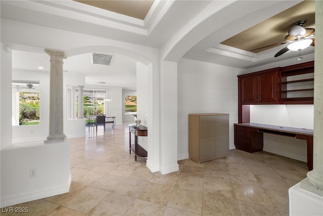 5067 Pensier St, Las Vegas, NV 89135 - unfurnished office featuring ceiling fan, a raised ceiling, ornate columns, built in desk, and arched walkways