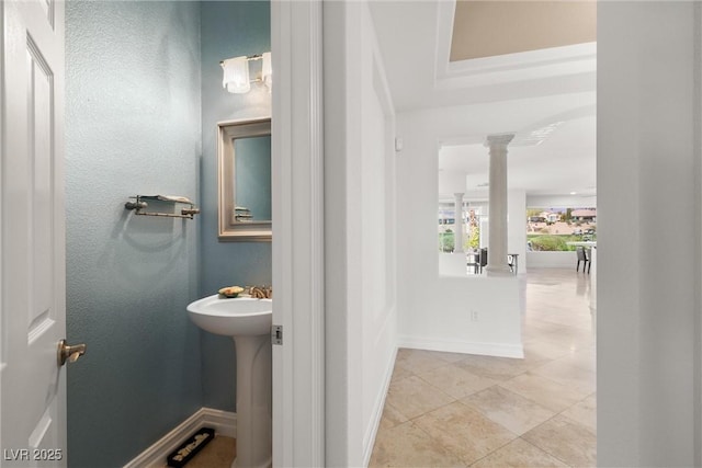 bathroom featuring decorative columns, baseboards, and tile patterned flooring