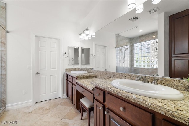 5067 Pensier St, Las Vegas, NV 89135 - full bath with double vanity, a tile shower, and tile patterned flooring