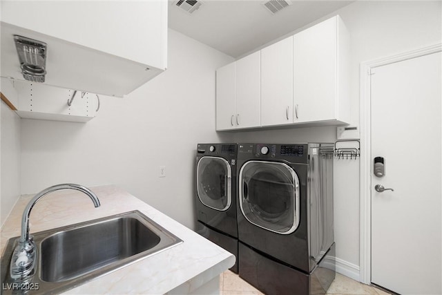 5067 Pensier St, Las Vegas, NV 89135 - laundry room with cabinet space and separate washer and dryer