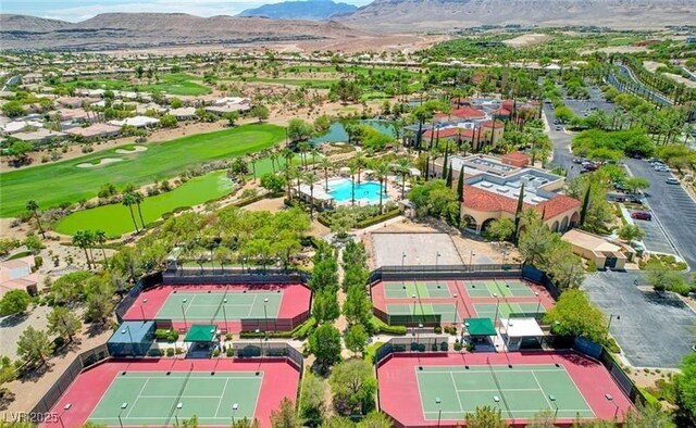 drone / aerial view of a local golf course and a water and mountain view