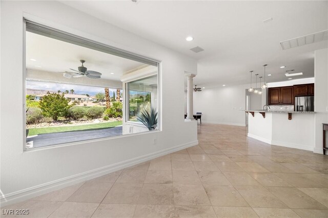 corridor featuring recessed lighting, light tile patterned flooring, and baseboards