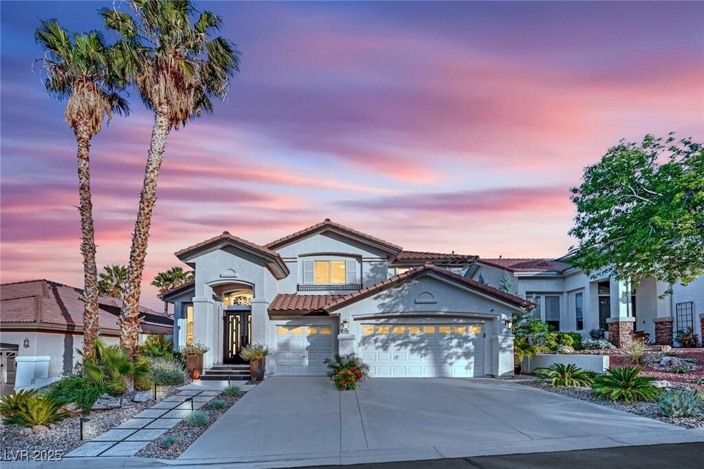 9705 Cameo Rose Ln, Las Vegas, NV 89134 - mediterranean / spanish house featuring a tile roof, driveway, stucco siding, and a garage
